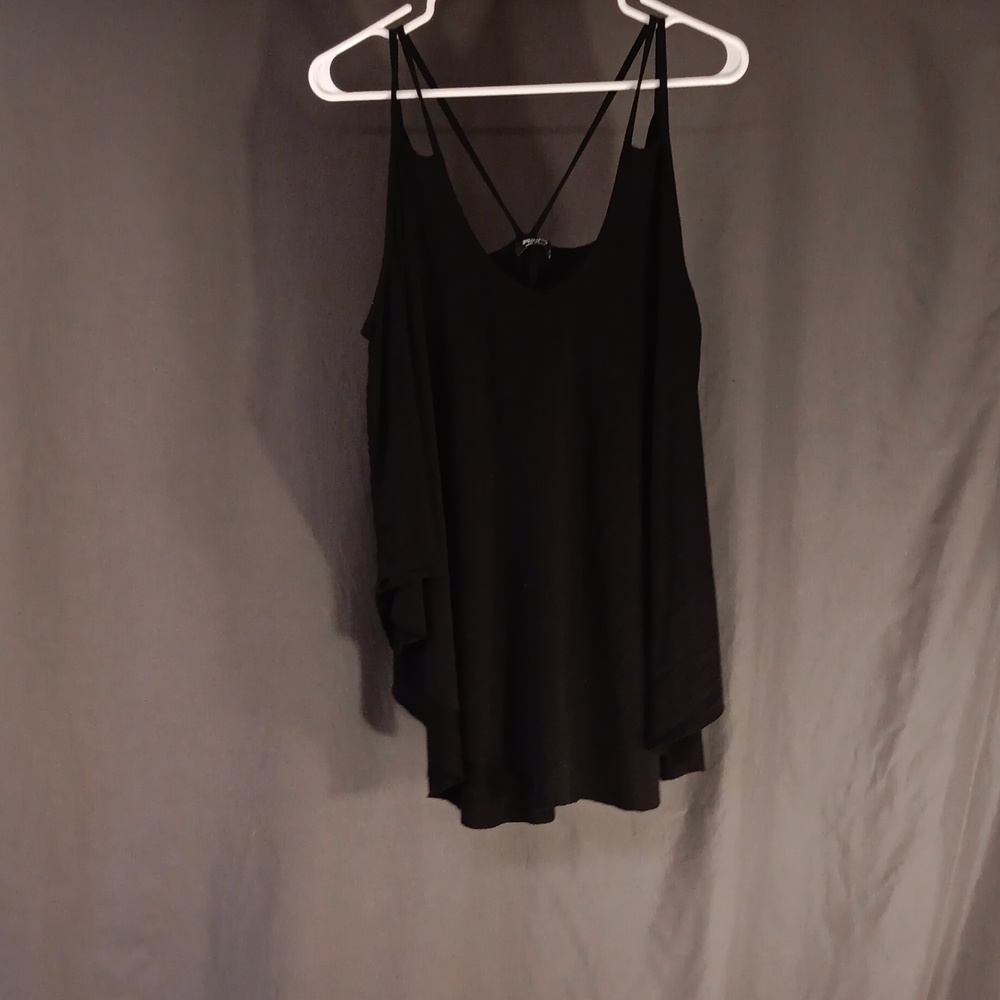 Sleeveless with spaghetti straps, that is loose fitting, black top.